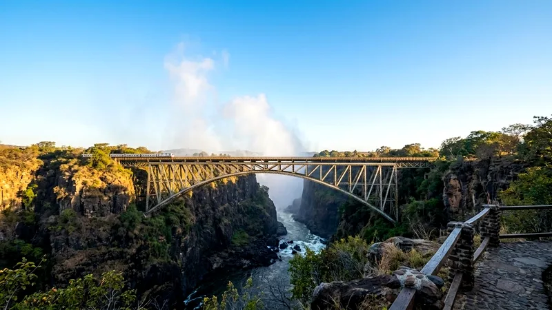Victoria Falls Bridge steel arch spanning the gorge at sunrise